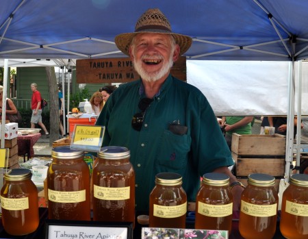 Roy Nettlebeck, owner of Tahuya River Apiaries, has something sweet to smile about -- honey! Photo copyright 2011 by Zachary D. Lyons.