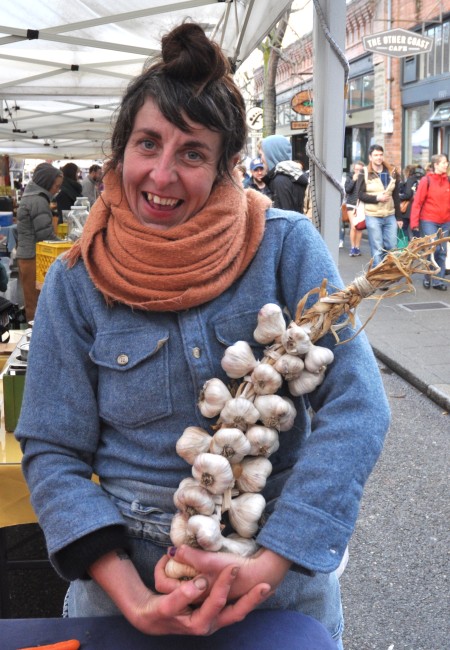 Carolina models a beautiful garlic braid from Kirsop Farm at Ballard Farmers Market. Copyright Zachary D. Lyons.