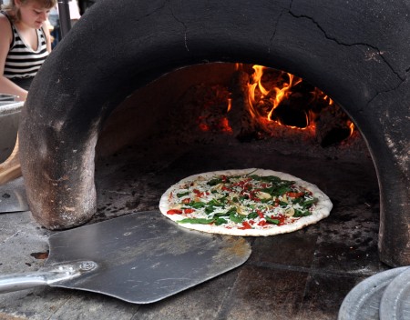 Loading pizza in the mobile oven at Veraci Pizza at Ballard Farmers Market. Copyright Zachary D. Lyons.